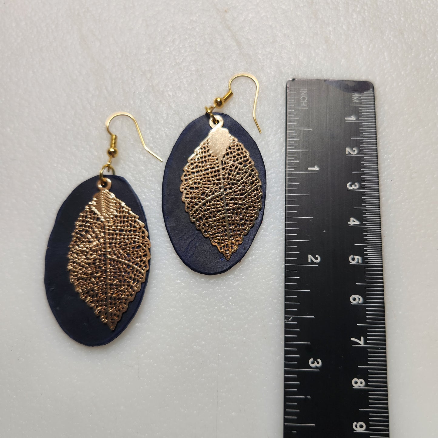 Dark Blue Oval Leather Earrings with Gold Toned Leaf Accent