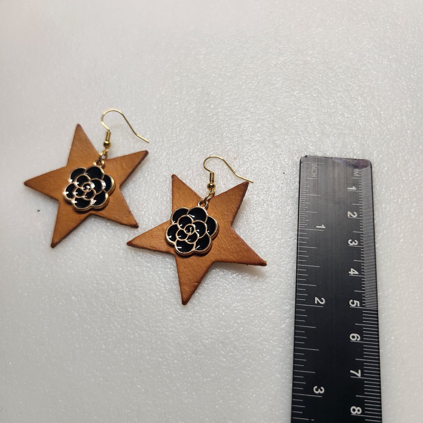 Lovely Yellow Star Shaped Earrings with Gold and Black Charm