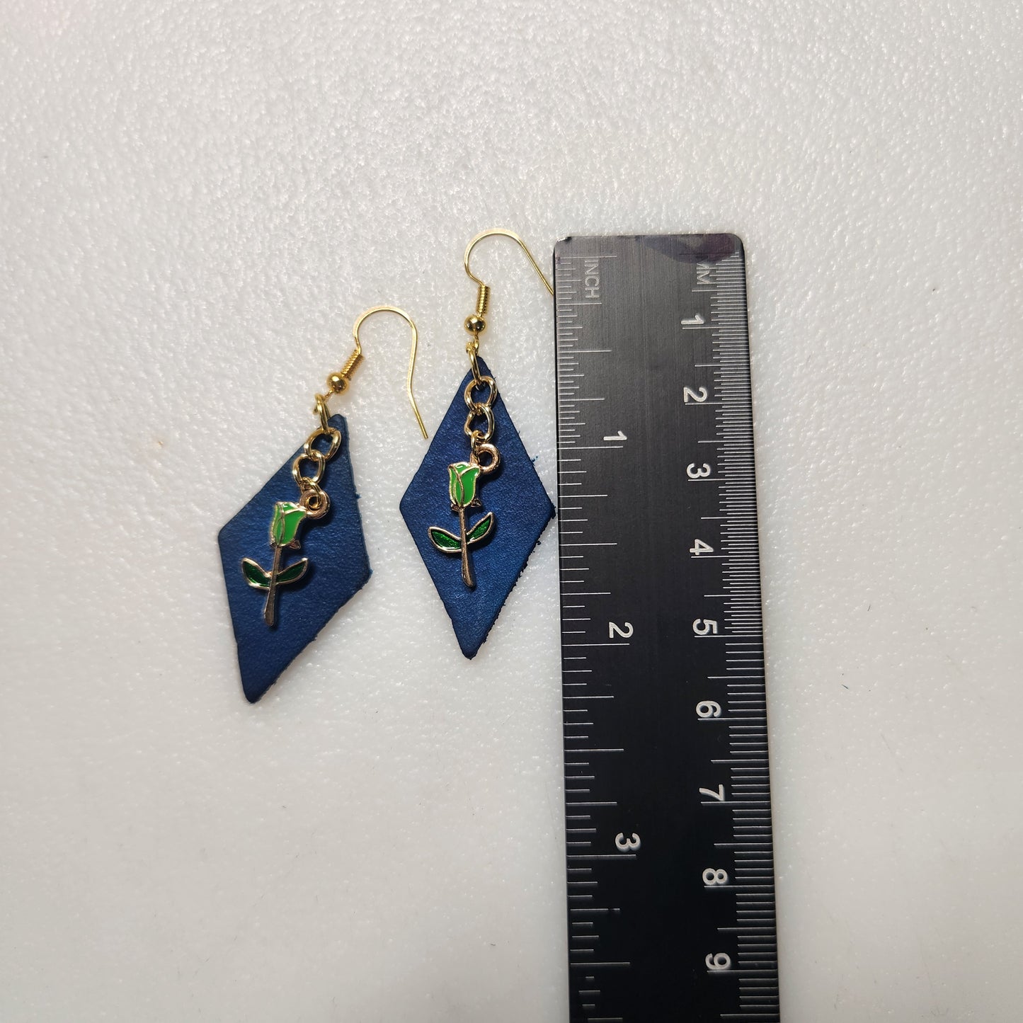 Striking Blue Leather Earring with Tiny Green Flower Charm