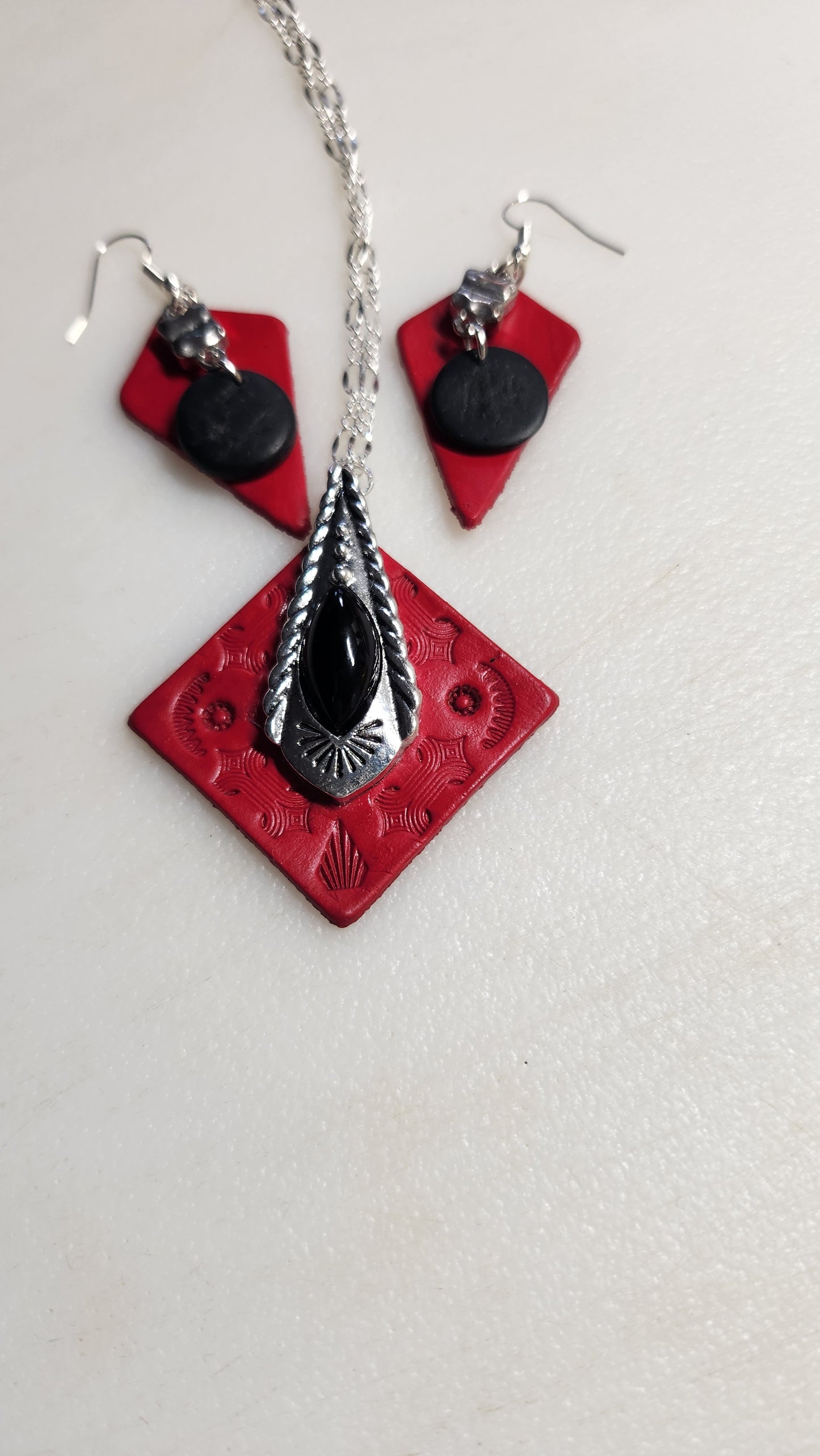 Beautiful tooled red leather pendant with a Classy Black and Silver Accent