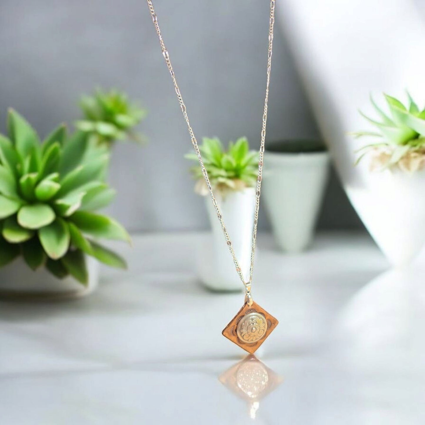 Small brown leather pendant with silver concho adornment