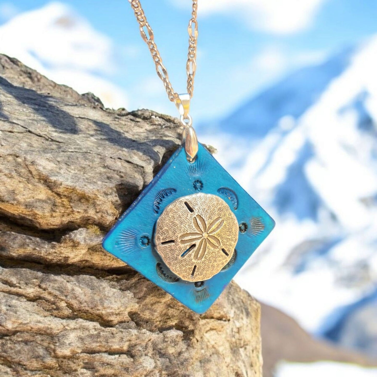 Turquoise pendant with sand dollar adornment