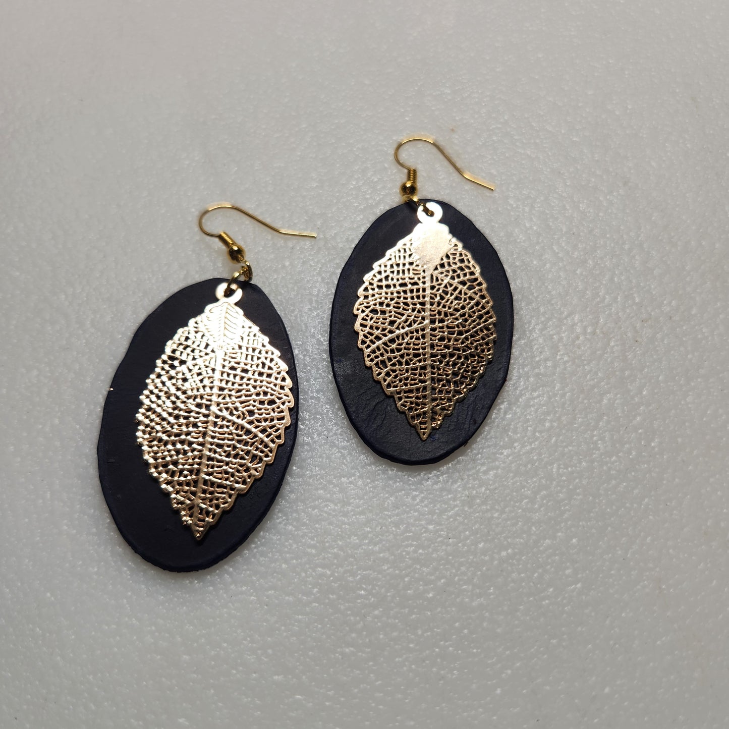 Dark Blue Oval Leather Earrings with Gold Toned Leaf Accent