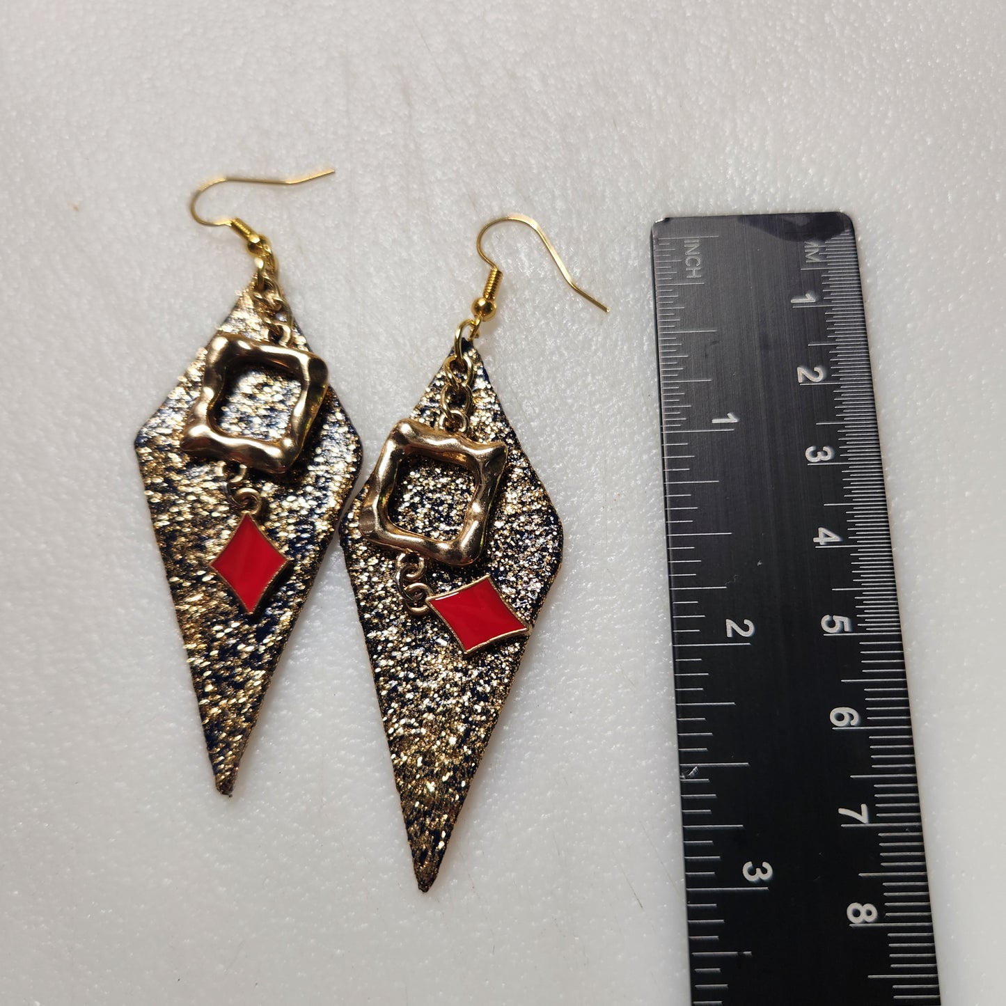 Gold Glitter Leather Earrings with Red Color Splash and Gold Toned Bangle