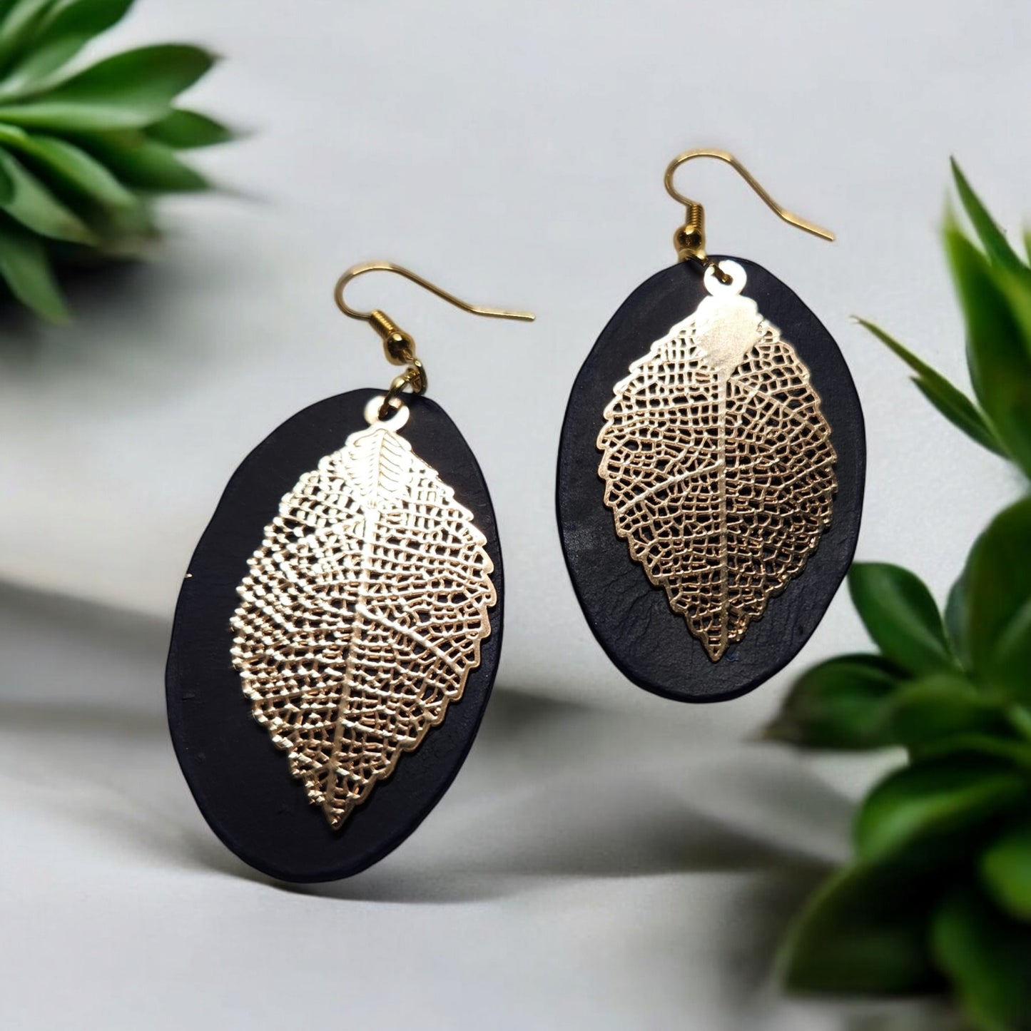 Dark Blue Oval Leather Earrings with Gold Toned Leaf Accent