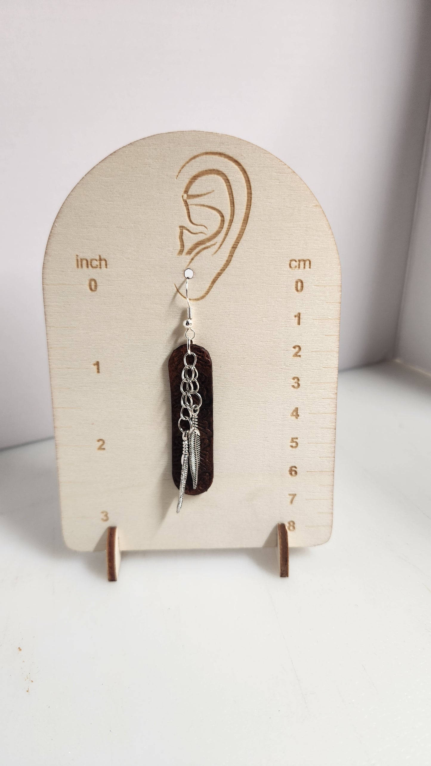 Simple and elegant tooled leather with silver toned feathers