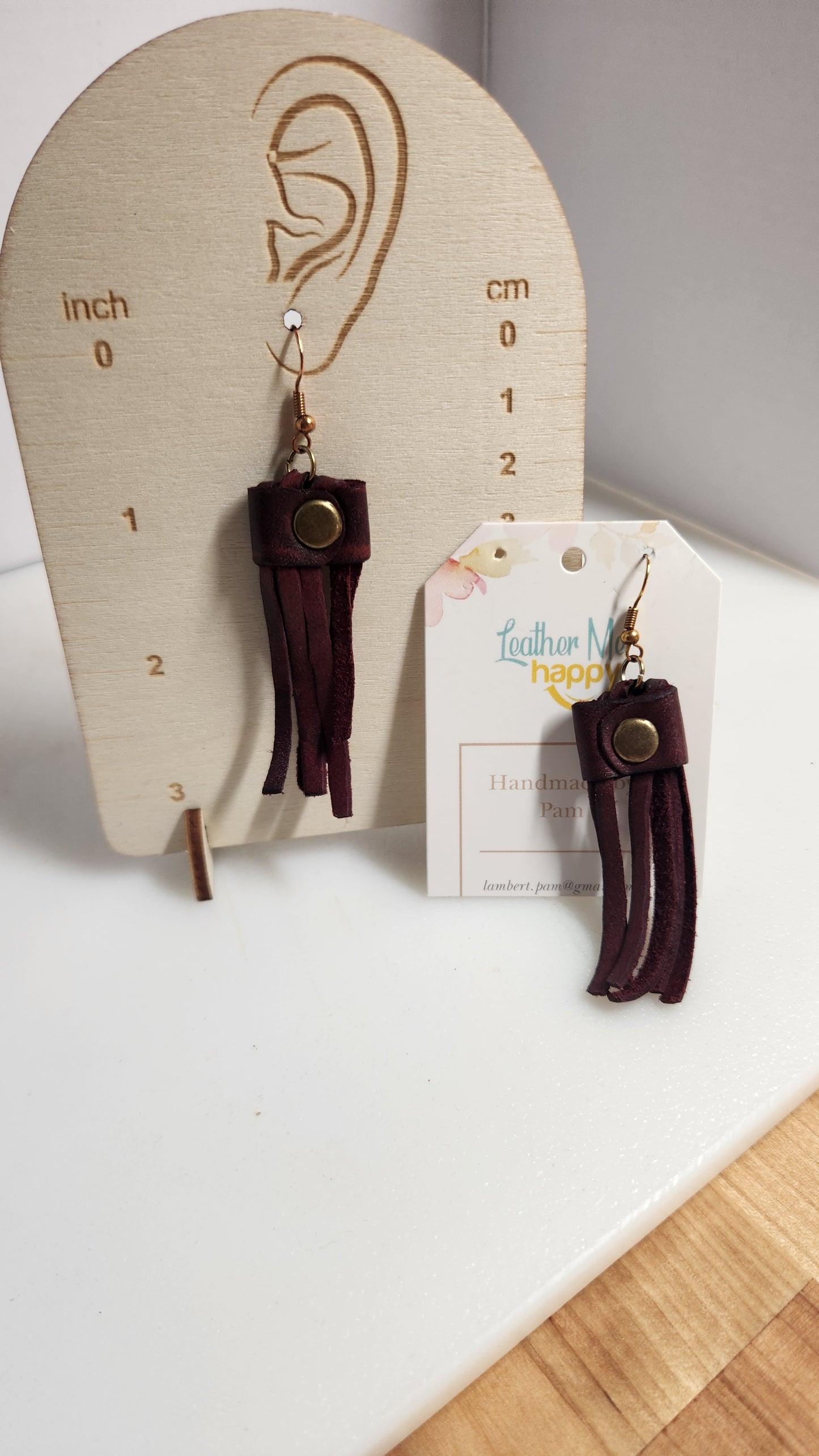 Classic mauve colored leather fringe earring