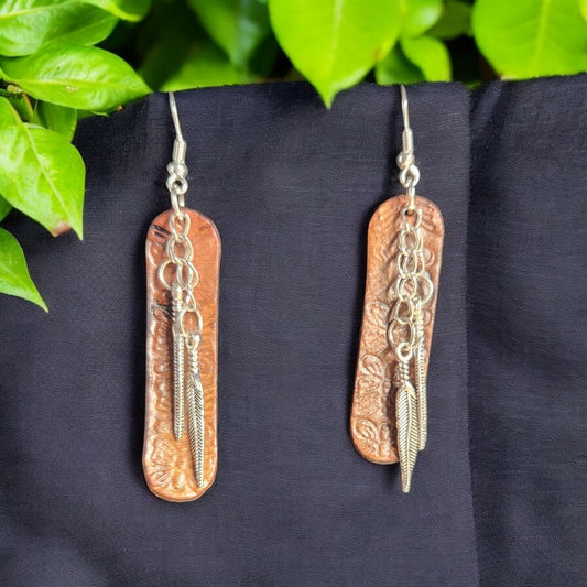 Simple and elegant tooled leather with silver toned feathers
